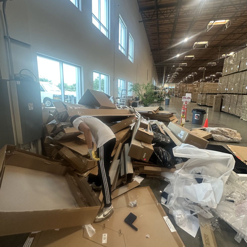 Office with desks, chairs and boxes being cleared out