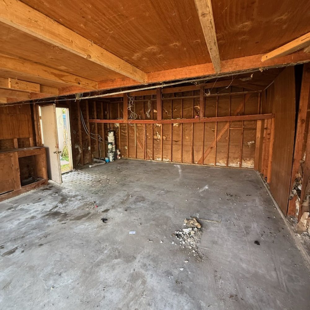 Empty garage with bare walls after junk removal