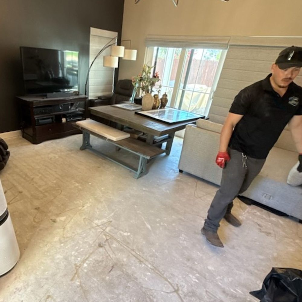 Roa crew member clearing furniture from a living room
