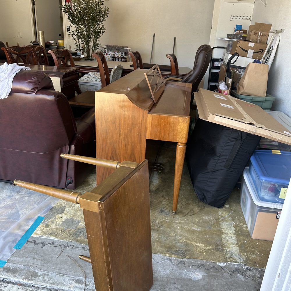 Old furniture and a piano ready for a house clean out