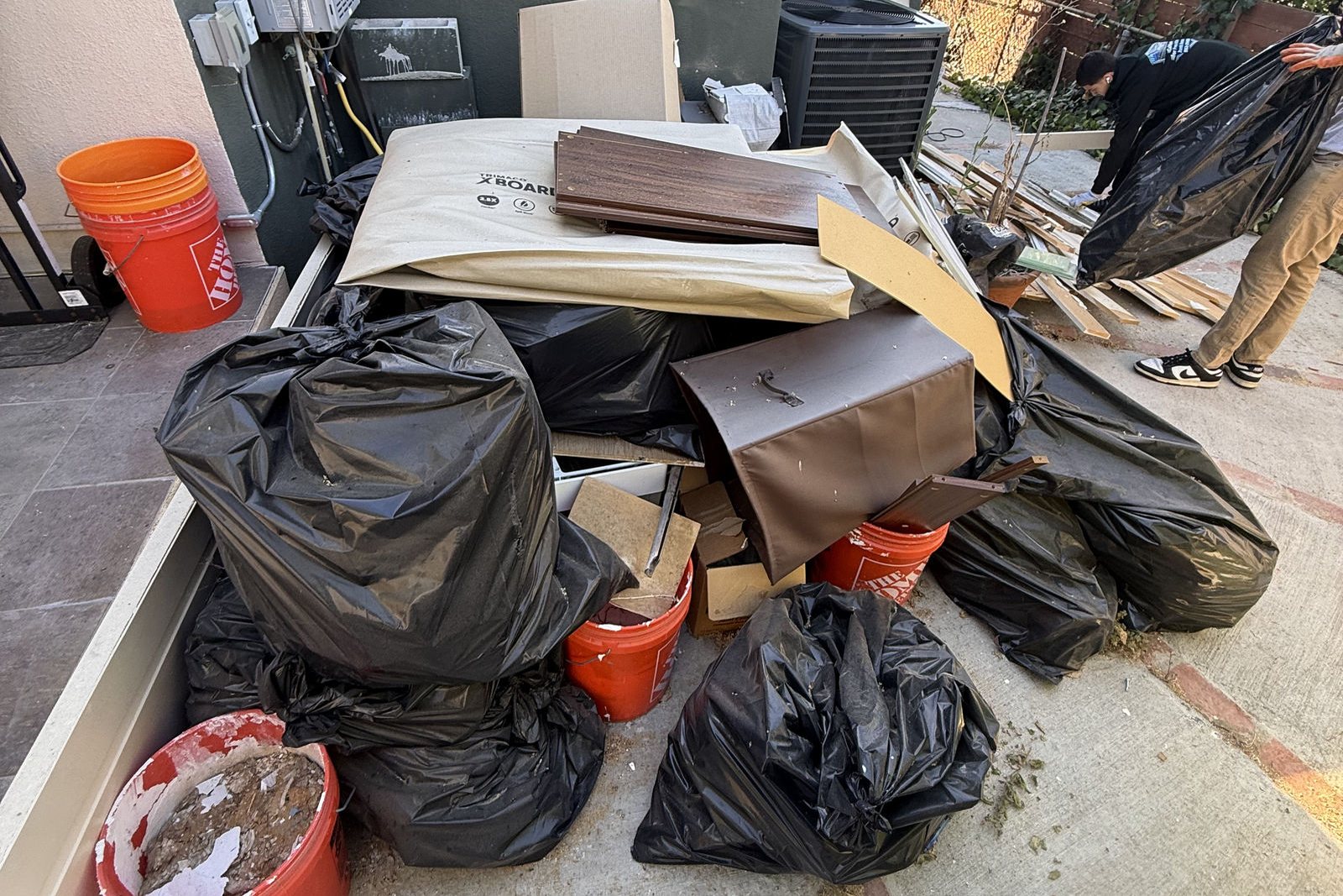 Bagged household junk and boxes waiting for pickup