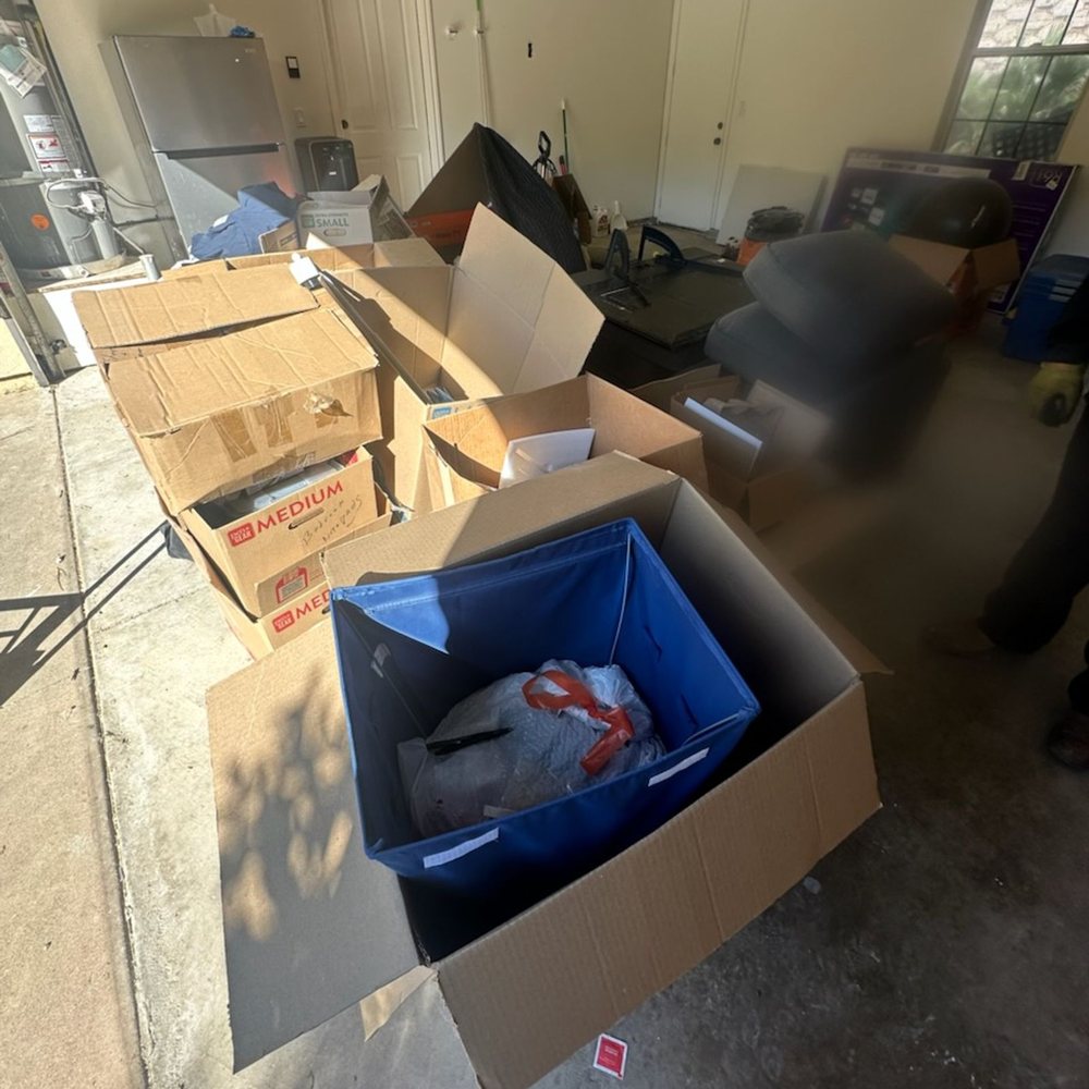 Boxes and storage bins piled in a garage before a clean out