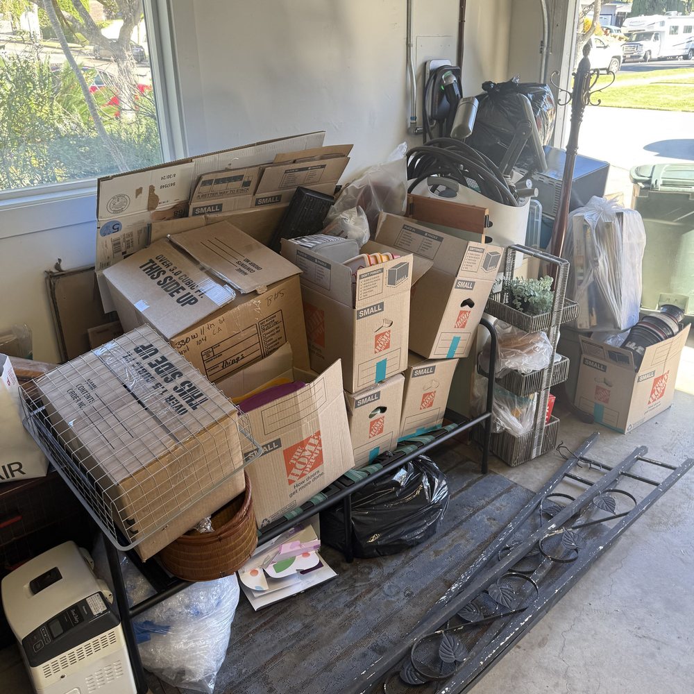 Garage stacked with boxes and household items before junk removal