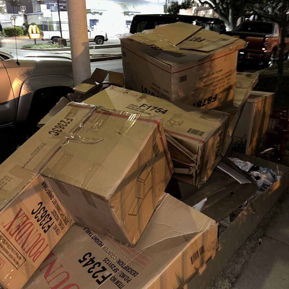 Stacks of moving boxes and household items ready for removal