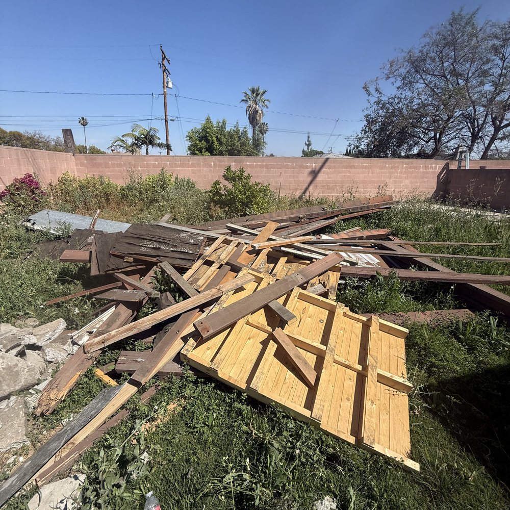 Old wooden shed taken apart and stacked for haul-away